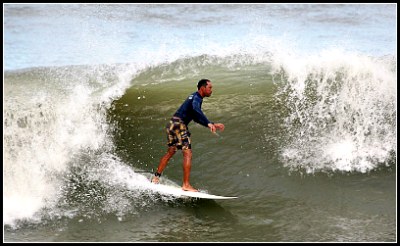 Man being tubed by small wave