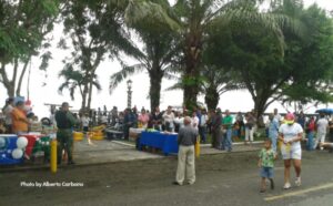 people listening to speech at waterfront park in puerto armuelles panama