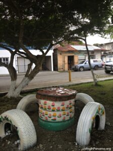 stoold make of tires, painted white, around a table also made of tires