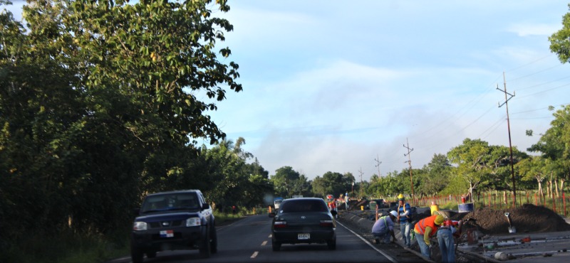 Traffic flows as men work on the road