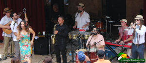 band playing on stage with woman singer