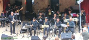 large band on stage, band members dressed all in black