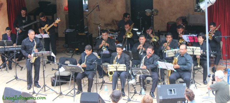 large band on stage, band members dressed all in black