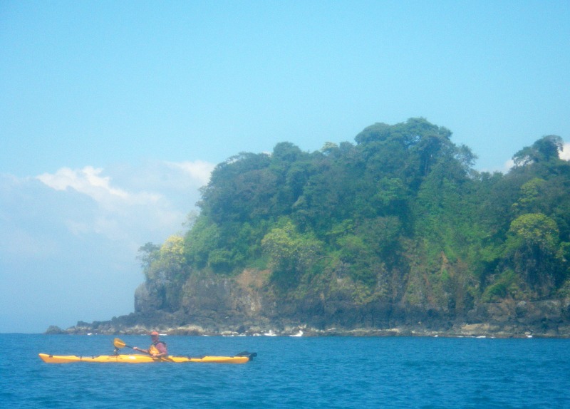 blue ocean and sky with yellow kayak slicing the water in Panama