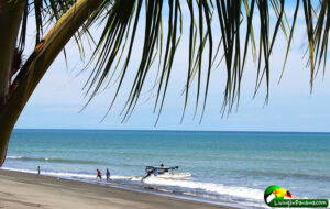 View of beach and the launching of a fishing boat
