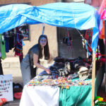 girl looking at wares at a street stall