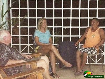 2 men and 1 woman sitting and talking