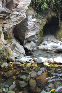 a couple partially submerged in a mountain stream