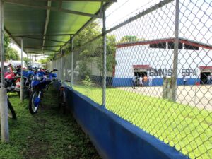 bikes parked and gym since through chainlink fence