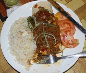 plate of food with white rice, beef over burrito, tomatos