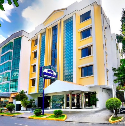front of a tall yellow hotel