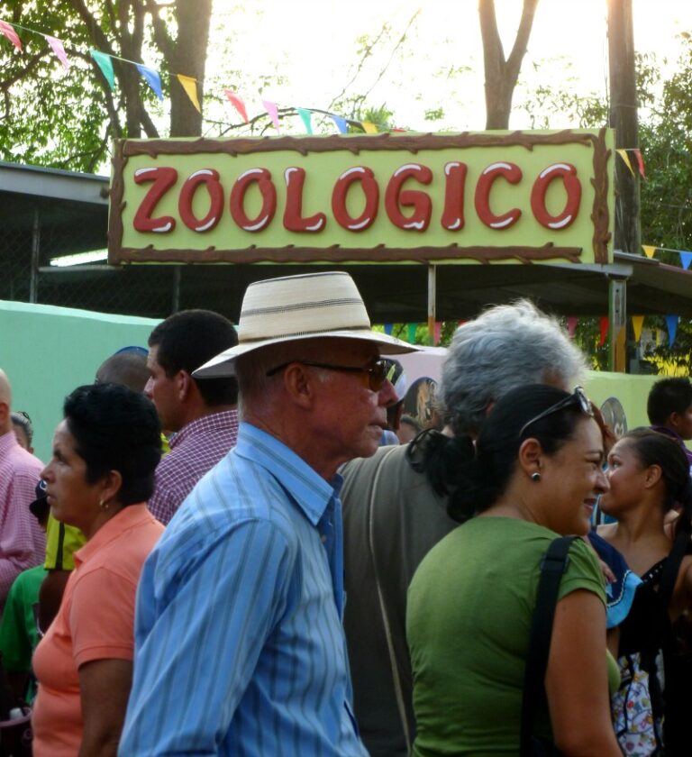 zoological sign and crowd of people passing by