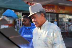 a delivery young man and old man wearing a fedora