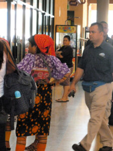 Native Indian in traditional garb and others at Albrook bus station in Panama City, Panama