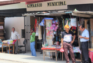 Men hanging out by make shift stores