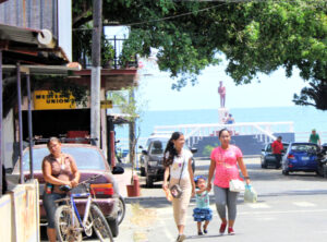 women and child walking in Puerto Armuelles, Panama