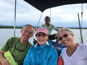 3 people and boatman in an open air boat