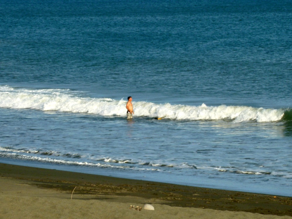 Photo of middle aged man standing in the surf