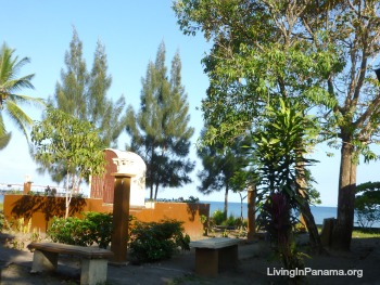 Small waterside park with benches and trees