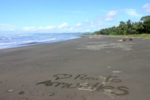 Photo of beach with writing in the sand